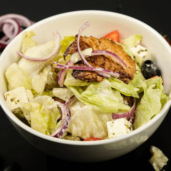 Valley Pizza's salad with grilled chicken, lettuce, red onions, feta cheese, and olives.